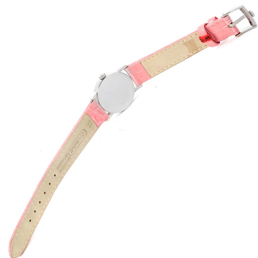 This Rolex Cellini 6110 Women
s White Gold Silver Dial 6110 Women
s White Gold Silver Dial watch shot shows its back case, pink leather strap, and buckle from an angled overhead view.