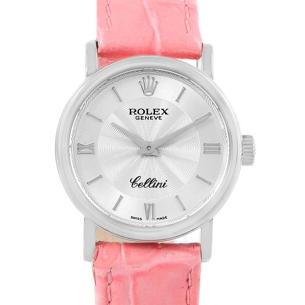 The Rolex Cellini 6110 Women
s White Gold Silver Dial 6110 Women
s White Gold Silver Dial watch is shown from a front angle, displaying its dial, bezel, case, and a portion of its pink strap.
