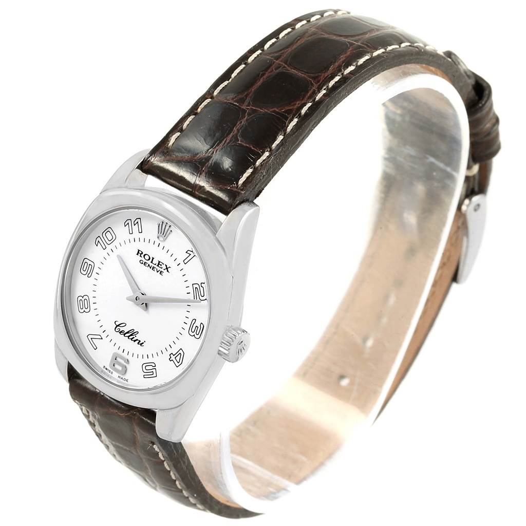 The image shows a side-angle view of a Rolex Cellini 6229 Women's White Gold White Dial 6229 Women's White Gold White Dial watch, highlighting its watch face, crown, and leather strap.