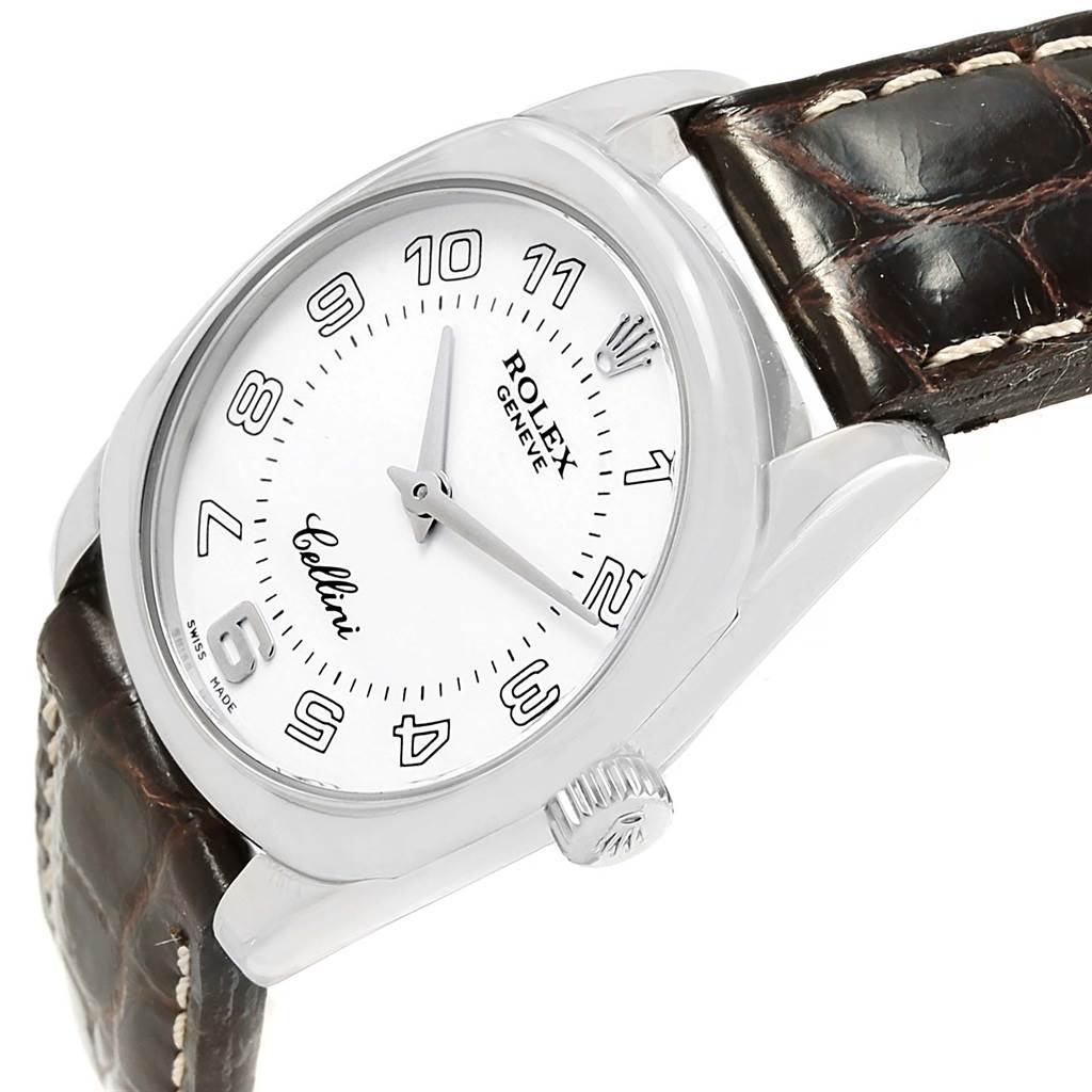 This image shows a close-up side angle of a Rolex Cellini 6229 Women's White Gold White Dial 6229 Women's White Gold White Dial watch emphasizing its face, bezel, and brown leather strap.