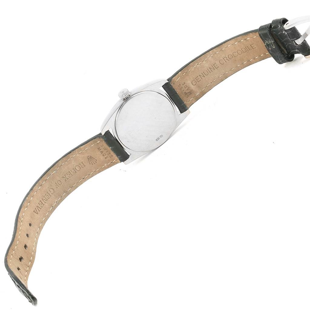 The image shows the back case and inner leather strap of a Rolex Cellini 6229 Women
s White Gold Black Dial 6229 Women
s White Gold Black Dial watch at a diagonal angle.