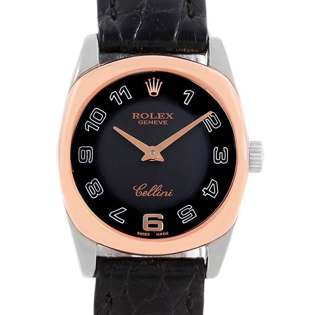 The Rolex Cellini 6229 Women
s White Gold Black Dial 6229 Women
s White Gold Black Dial watch is shown from a front angle, displaying its black dial, gold hands, and leather strap.