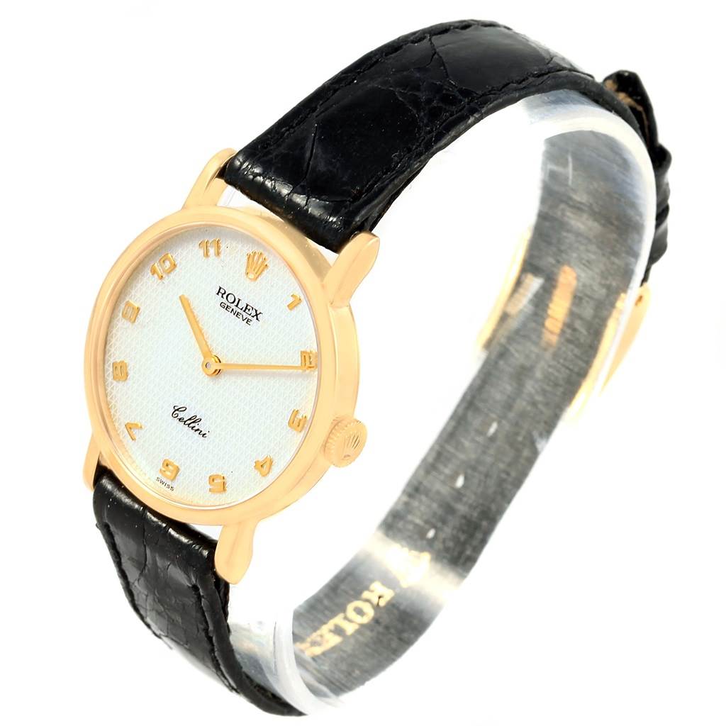 This image shows a Rolex Cellini 5109 Women's Yellow Gold Mother of Pearl Dial 5109 Women's Yellow Gold Mother of Pearl Dial watch at a slight side angle, highlighting its gold case, white dial, black leather strap, and crown.