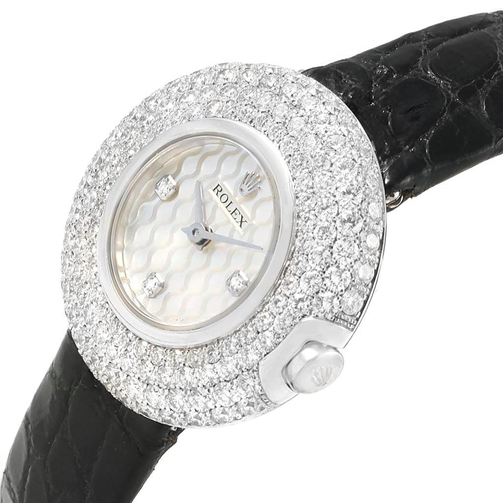 This image shows a Rolex Cellini 6201 Women's White Gold Mother of Pearl Dial 6201 Women's White Gold Mother of Pearl Dial watch from an angled view, focusing on the diamond-encrusted bezel, dial, and leather strap.