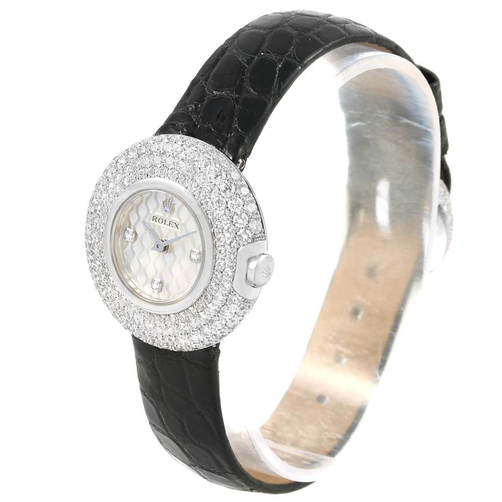 The Rolex Cellini 6201 Women's White Gold Mother of Pearl Dial 6201 Women's White Gold Mother of Pearl Dial watch is shown at a slight angle, displaying its diamond-studded bezel and black leather strap.