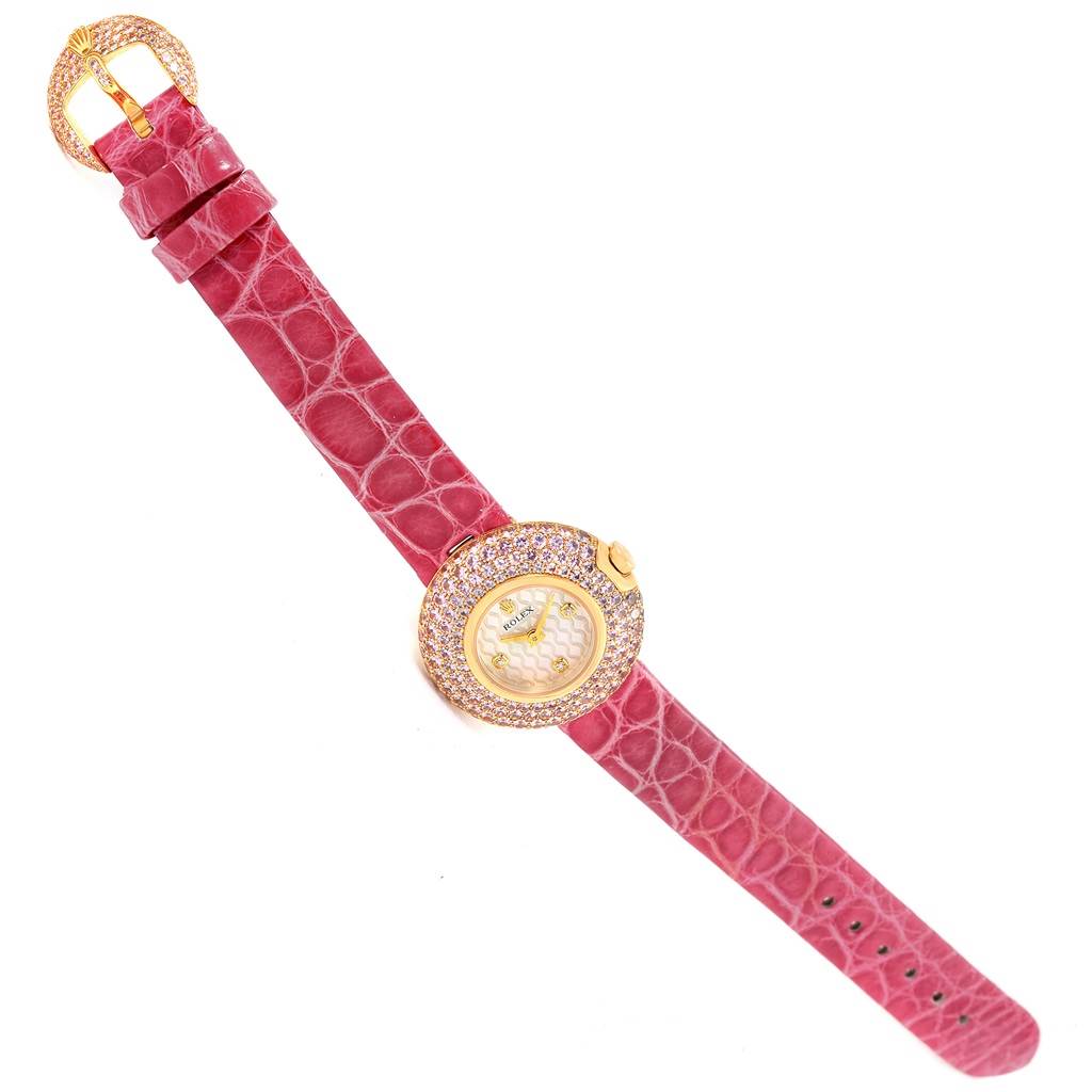 The image shows a Rolex Cellini 6201 Women's Yellow Gold Mother of Pearl Dial 6201 Women's Yellow Gold Mother of Pearl Dial watch laid flat, displaying its pink strap, ornate gold buckle, and gold bezel with embedded gemstones.