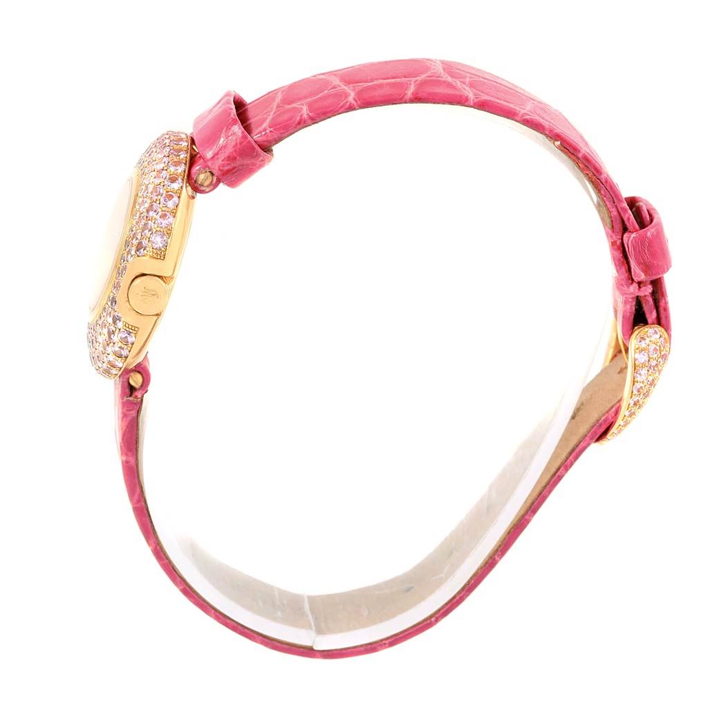 This image shows a Rolex Cellini 6201 Women's Yellow Gold Mother of Pearl Dial 6201 Women's Yellow Gold Mother of Pearl Dial watch from the side, highlighting its pink strap and diamond-encrusted case.