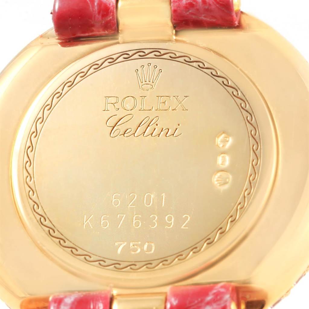This photo shows the back case of a Rolex Cellini 6201 Women's Yellow Gold Mother of Pearl Dial 6201 Women's Yellow Gold Mother of Pearl Dial model watch with its engravings and part of the strap.