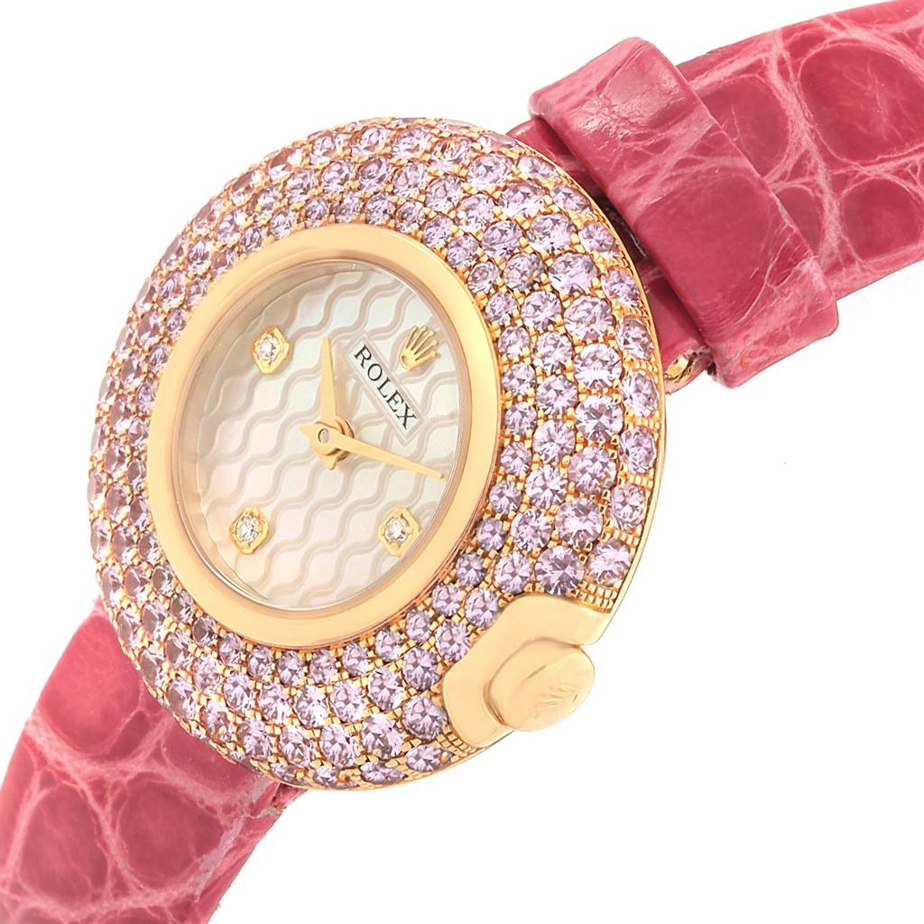 The Rolex Cellini 6201 Women's Yellow Gold Mother of Pearl Dial 6201 Women's Yellow Gold Mother of Pearl Dial watch is shown at an oblique angle, highlighting its diamond-studded bezel and pink leather strap.