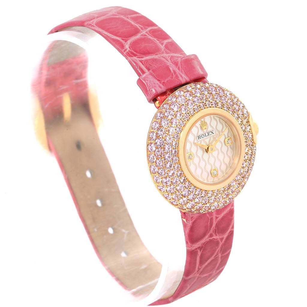 The Rolex Cellini 6201 Women's Yellow Gold Mother of Pearl Dial 6201 Women's Yellow Gold Mother of Pearl Dial watch is shown at a three-quarter angle, displaying its bejeweled bezel, dial, and pink leather strap.