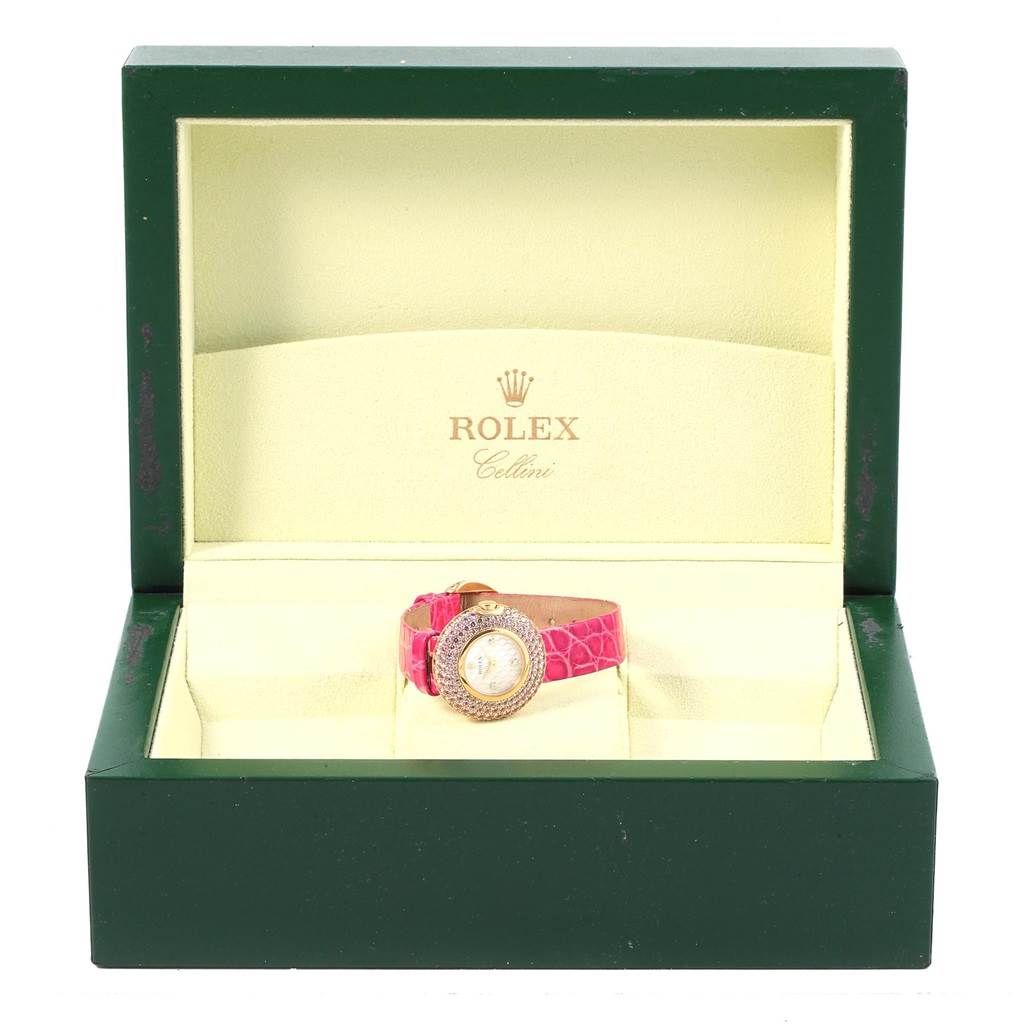 This image shows a Rolex Cellini 6201 Women's Yellow Gold Mother of Pearl Dial 6201 Women's Yellow Gold Mother of Pearl Dial watch with a pink strap in its open display box.
