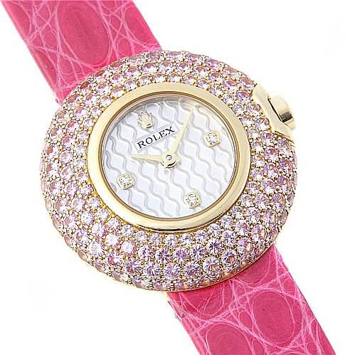 The image shows a top view of a Rolex Cellini 6201 Women's Yellow Gold Mother of Pearl Dial 6201 Women's Yellow Gold Mother of Pearl Dial watch with a pink strap and a diamond-encrusted bezel.