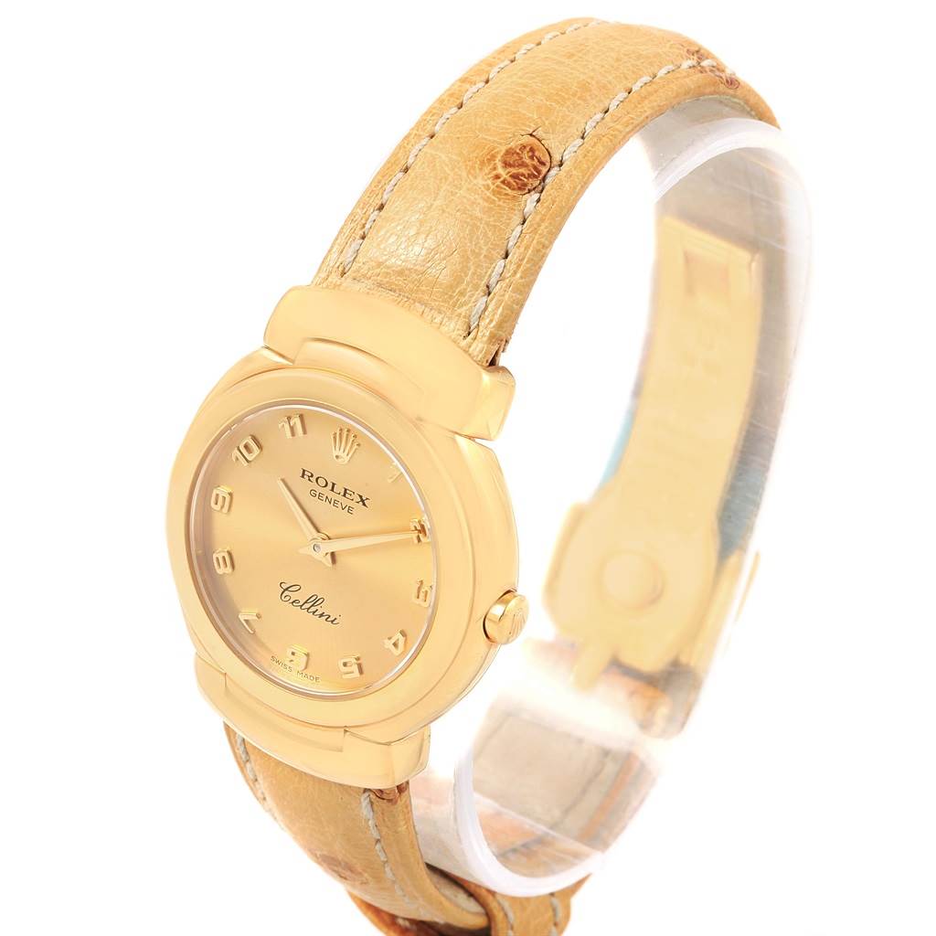 The Rolex Cellini 6621 Women's Yellow Gold Champagne Dial 6621 Women's Yellow Gold Champagne Dial watch is shown at a three-quarter angle, highlighting its gold case, beige dial, and tan leather strap.