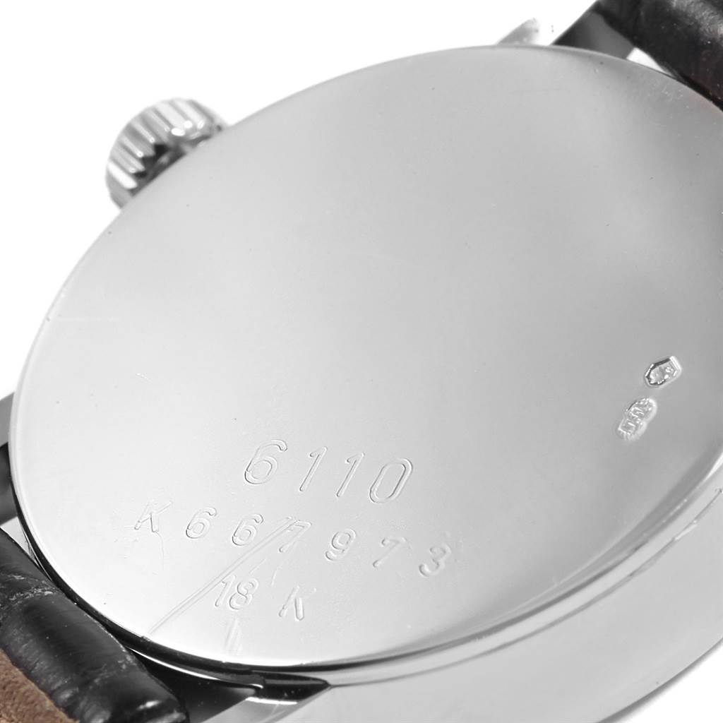 This image shows the back case, crown, and part of the strap of a Rolex Cellini 6110 Women's White Gold Silver Dial 6110 Women's White Gold Silver Dial model watch.