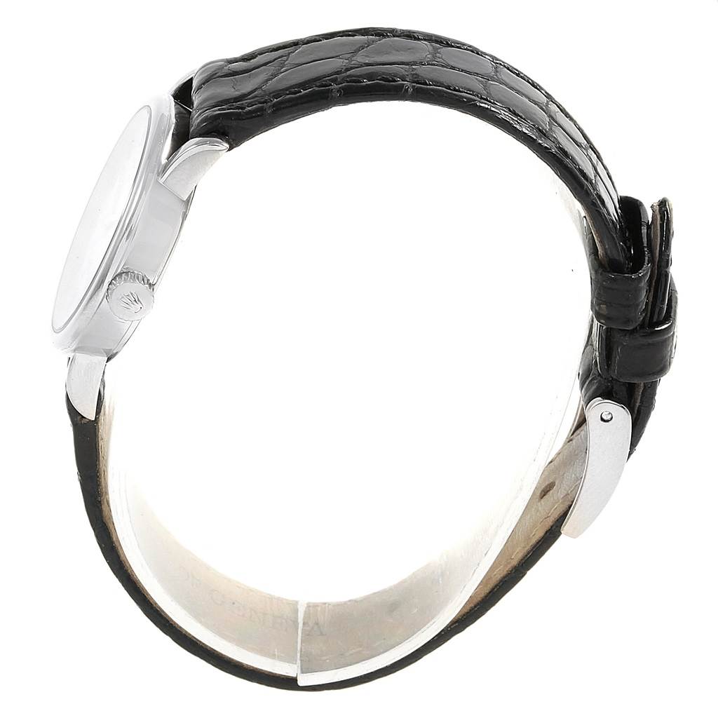 The side view shows the case, crown, and black leather strap of the Rolex Cellini 6110 Women's White Gold Silver Dial 6110 Women's White Gold Silver Dial watch.