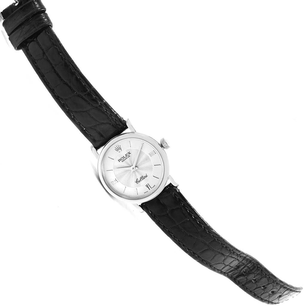 The Rolex Cellini 6110 Women's White Gold Silver Dial 6110 Women's White Gold Silver Dial model watch is displayed flat, showing the face, bezel, crown, and black leather strap.