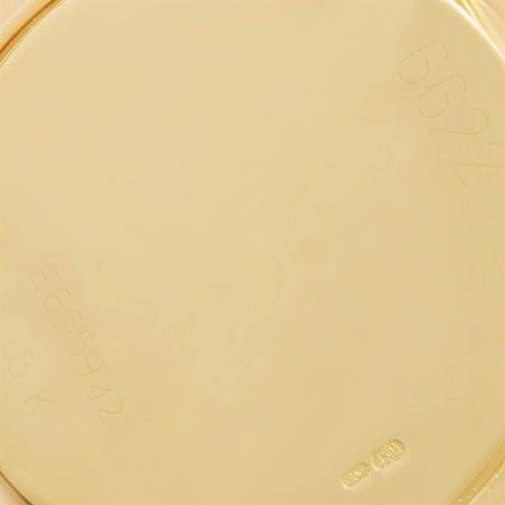 The image shows a close-up of the back case of a Rolex Cellini 6622 Women's Yellow Gold White Dial 6622 Women's Yellow Gold White Dial watch, highlighting the engraved model and serial numbers.