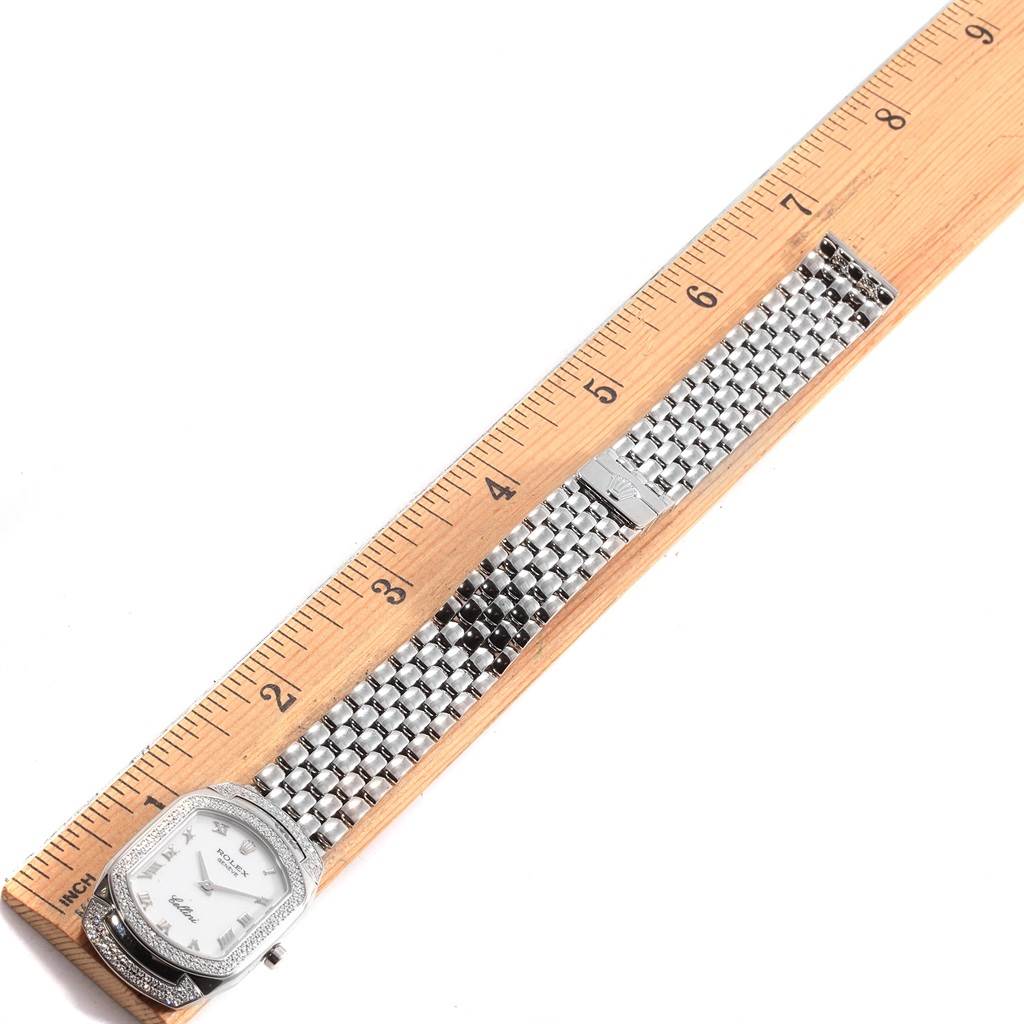 The image shows a top-down view of a Rolex Cellini 6693 Women's White Gold White Dial 6693 Women's White Gold White Dial watch laid alongside a ruler, displaying the entire watch face and band.