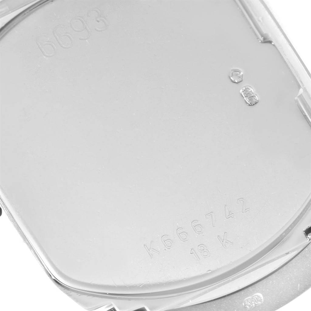 This image shows a close-up view of the back case of a Rolex Cellini 6693 Women's White Gold White Dial 6693 Women's White Gold White Dial watch with various engraved markings.