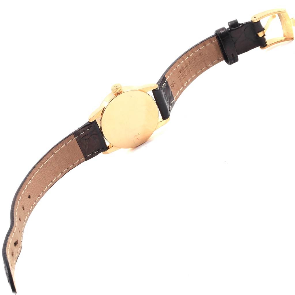 The image shows the back view of a Rolex Cellini 6111 Women's Yellow Gold Champagne Dial 6111 Women's Yellow Gold Champagne Dial watch, highlighting its gold case and leather strap with a gold buckle.