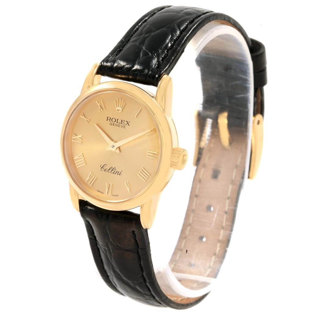 The Rolex Cellini 6111 Women's Yellow Gold Champagne Dial 6111 Women's Yellow Gold Champagne Dial watch is shown at a three-quarter angle, displaying the face, crown, and leather strap.