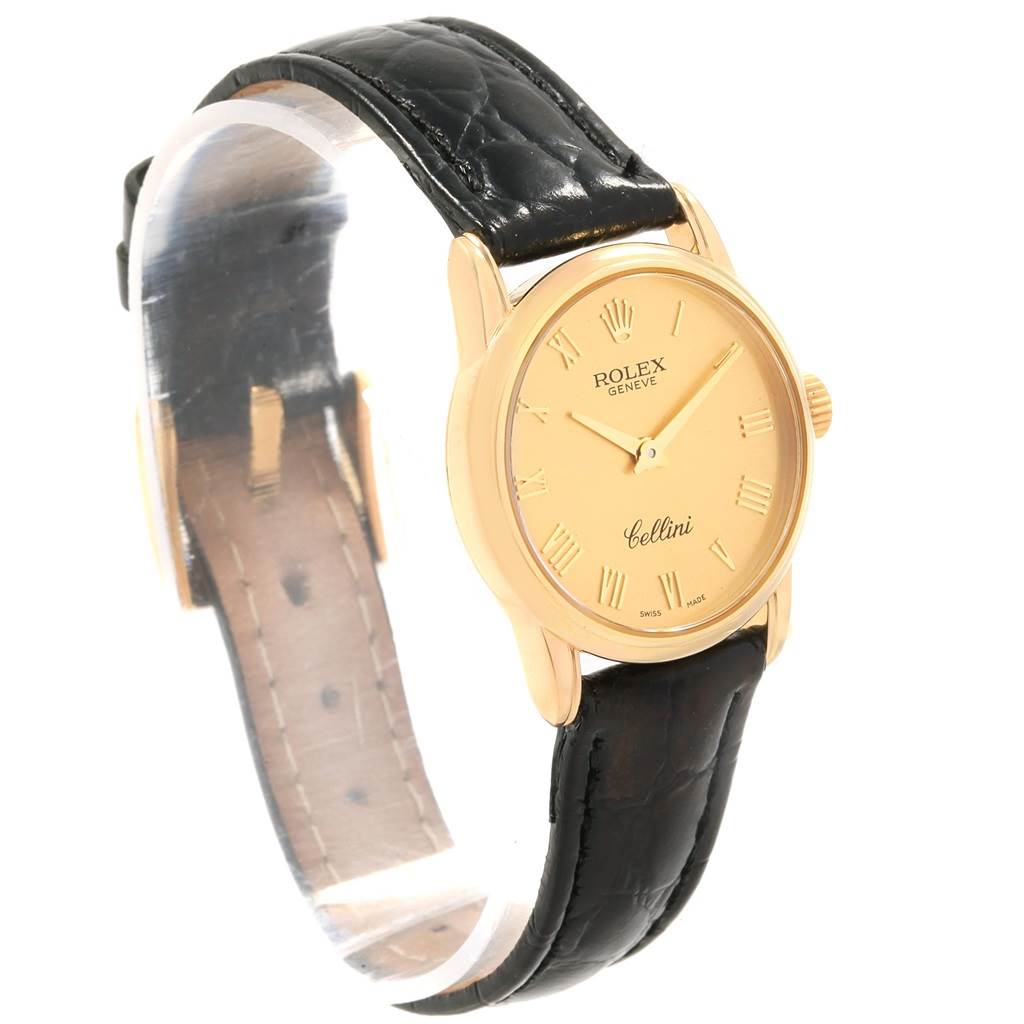 The image shows a Rolex Cellini 6111 Women's Yellow Gold Champagne Dial 6111 Women's Yellow Gold Champagne Dial watch at a slight side angle, showcasing the gold face, black leather strap, and gold case.