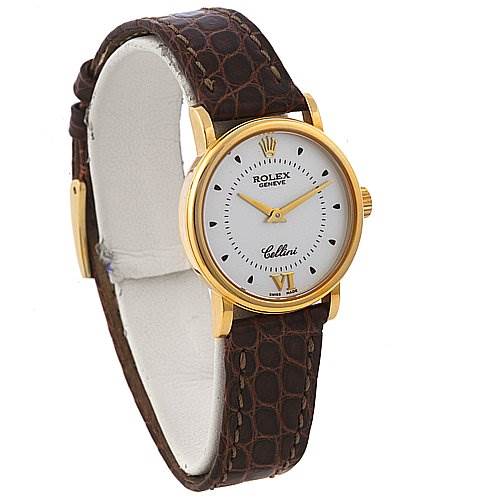 This image shows a Rolex Cellini 6110 Women's Yellow Gold Silver Dial 6110 Women's Yellow Gold Silver Dial watch at an angle, highlighting its gold case, white dial, and brown leather strap.