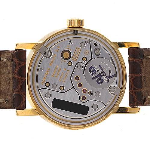 This image shows the back side of a Rolex Cellini 6110 Women's Yellow Gold Silver Dial 6110 Women's Yellow Gold Silver Dial watch, displaying its internal mechanism and the leather straps.