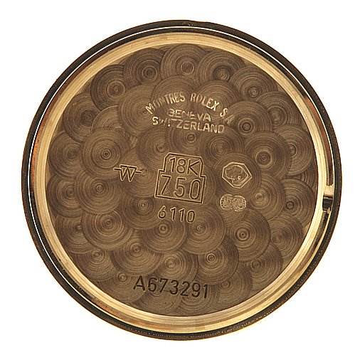 This image shows the inside of the case back of a Rolex Cellini 6110 Women's Yellow Gold Silver Dial 6110 Women's Yellow Gold Silver Dial watch, marked with details such as "18K 750," “6110,” and a serial number.