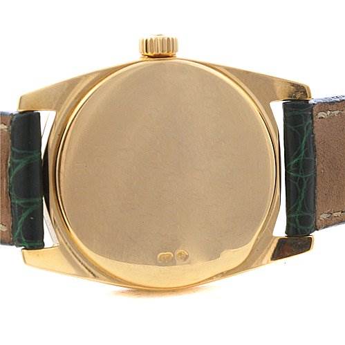 This image shows the back view of a Rolex Cellini 6229 Women's Yellow Gold White Dial 6229 Women's Yellow Gold White Dial watch case with no visible markings and part of the leather strap.