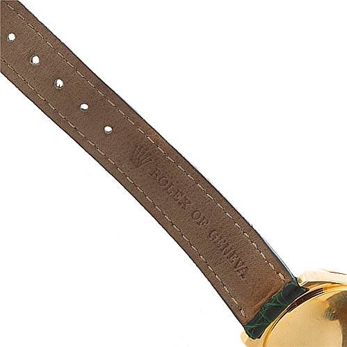 The image shows the side angle of a Rolex Cellini 6229 Women's Yellow Gold White Dial 6229 Women's Yellow Gold White Dial watch, focusing on part of the leather strap and the gold watch case.