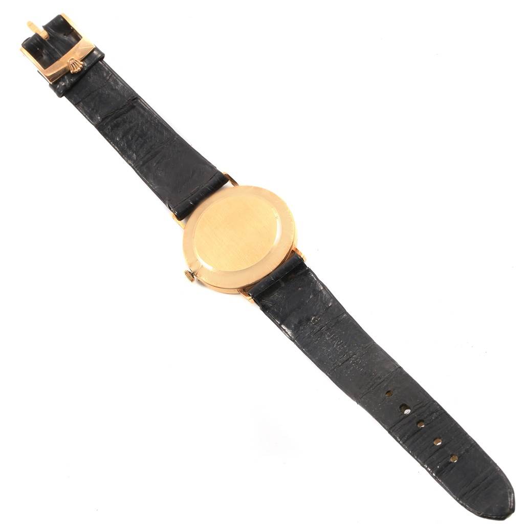 The image shows the back view of a Rolex Cellini 3833 Men's Yellow Gold White Dial 3833 Men's Yellow Gold White Dial watch, displaying the caseback, crown, and leather strap with buckle.