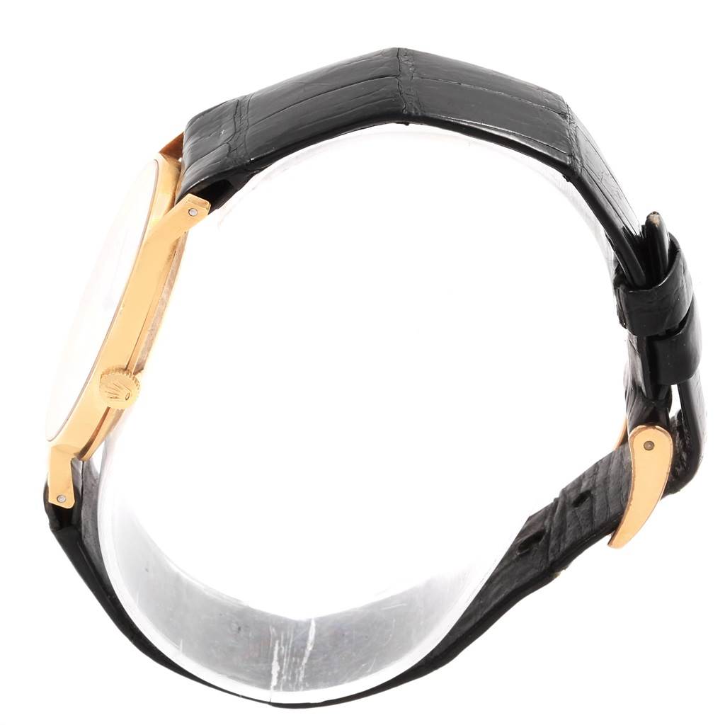 The image shows a side view of a Rolex Cellini 3833 Men's Yellow Gold White Dial 3833 Men's Yellow Gold White Dial watch, highlighting its black leather strap and gold case.