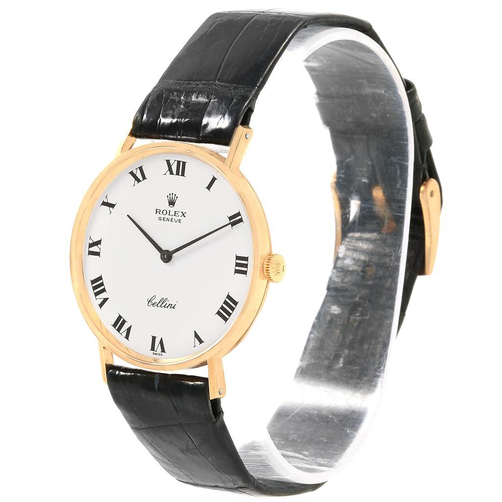 The image shows a Rolex Cellini 3833 Men's Yellow Gold White Dial 3833 Men's Yellow Gold White Dial watch from a slight side angle, highlighting its white dial with Roman numerals, gold case, and black leather strap.