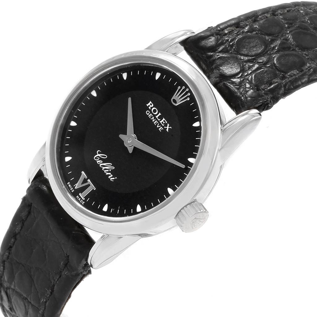 The image shows a Rolex Cellini 6111 Women's White Gold Black Dial 6111 Women's White Gold Black Dial watch face and part of the black leather strap at an angled top-down view.