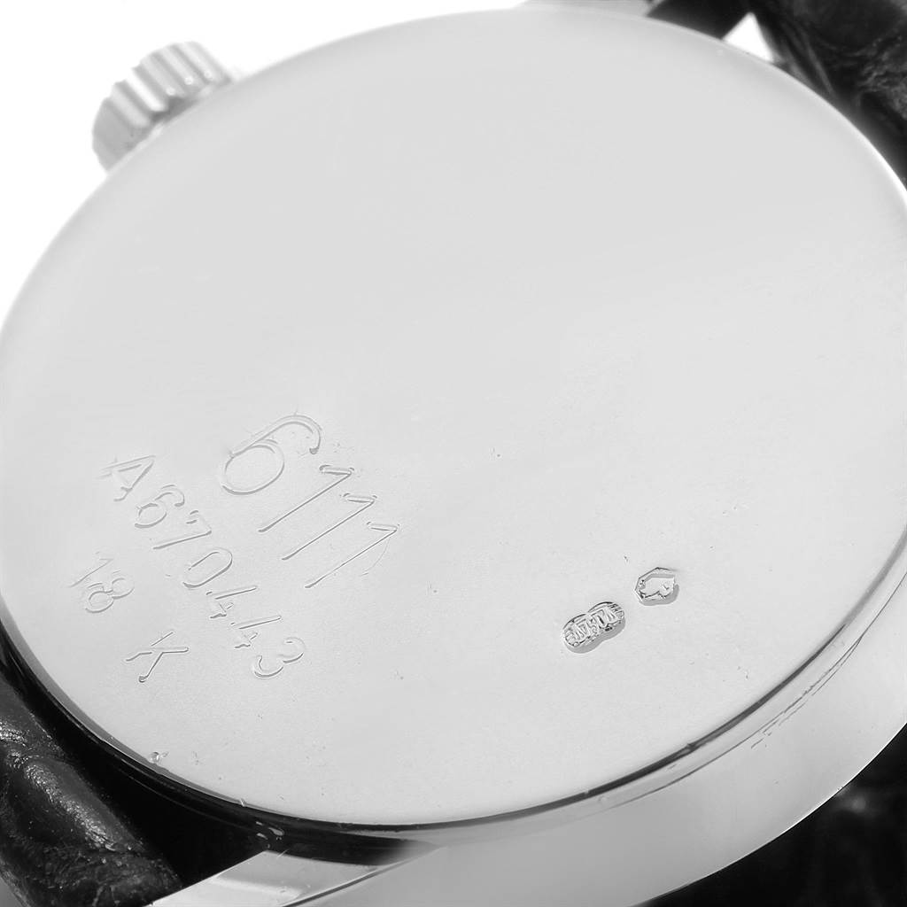 This image shows the back case of a Rolex Cellini 6111 Women's White Gold Black Dial 6111 Women's White Gold Black Dial watch, including the crown and engraved serial number.