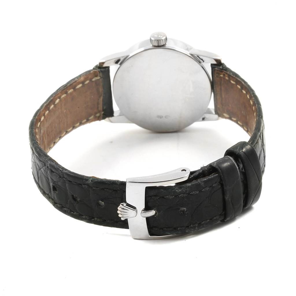 The image shows the back view of a Rolex Cellini 6111 Women's White Gold Black Dial 6111 Women's White Gold Black Dial watch with its black leather strap and metal clasp.