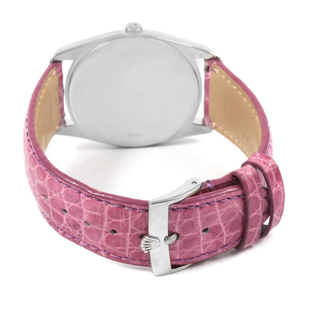This image shows the back of the Rolex Cellini 4233 Women's White Gold Black Dial 4233 Women's White Gold Black Dial watch and its pink leather strap with a clasp.