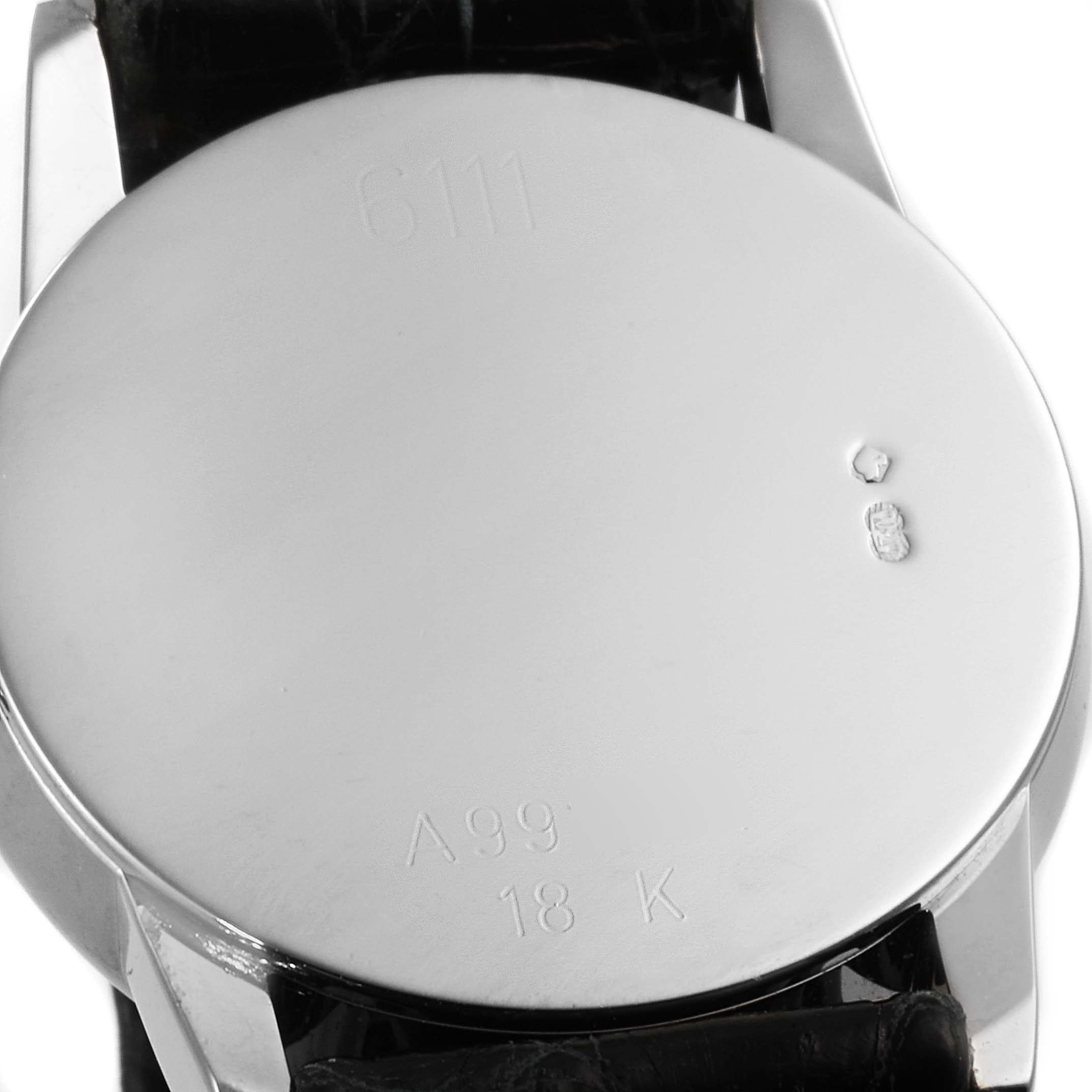 The image shows the back casing of a Rolex Cellini 6111 Women's White Gold Grey Dial 6111 Women's White Gold Grey Dial watch, displaying its 18K hallmark and serial number.