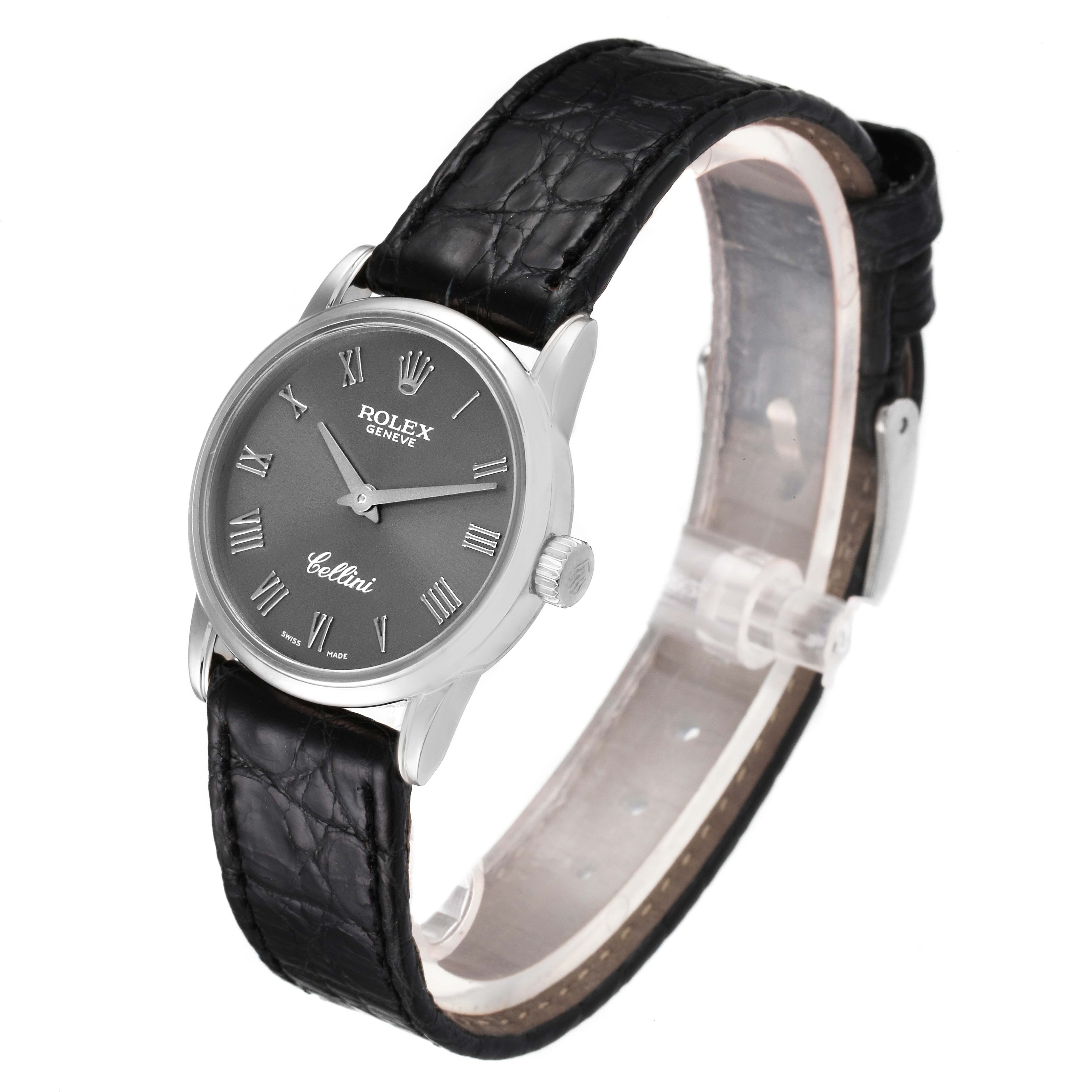 The Rolex Cellini 6111 Women's White Gold Grey Dial 6111 Women's White Gold Grey Dial watch is shown at a slight angle showcasing its face, crown, and black leather strap.