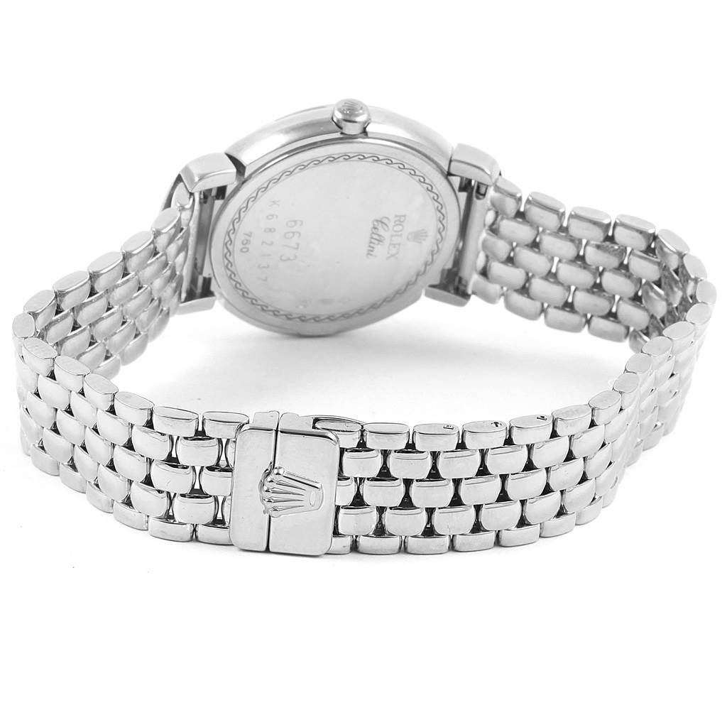 The image shows the back view of a Rolex Cellini 6673 Women's White Gold White Dial 6673 Women's White Gold White Dial watch, highlighting its case back and metal bracelet with a clasp.