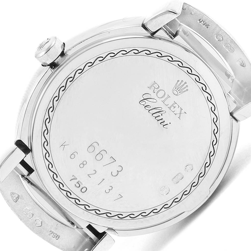 The image shows the back case of a Rolex Cellini 6673 Women's White Gold White Dial 6673 Women's White Gold White Dial watch, with engraved model and serial numbers.