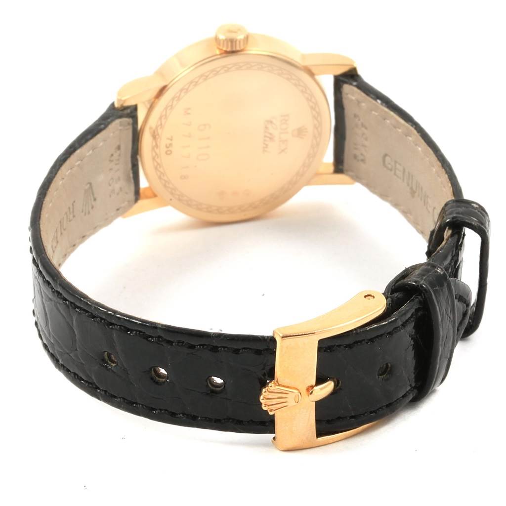 This image shows the Rolex Cellini 6110 Women
s Yellow Gold Grey Dial 6110 Women
s Yellow Gold Grey Dial watch from the back, highlighting its case, crown, and black leather strap with a gold clasp.