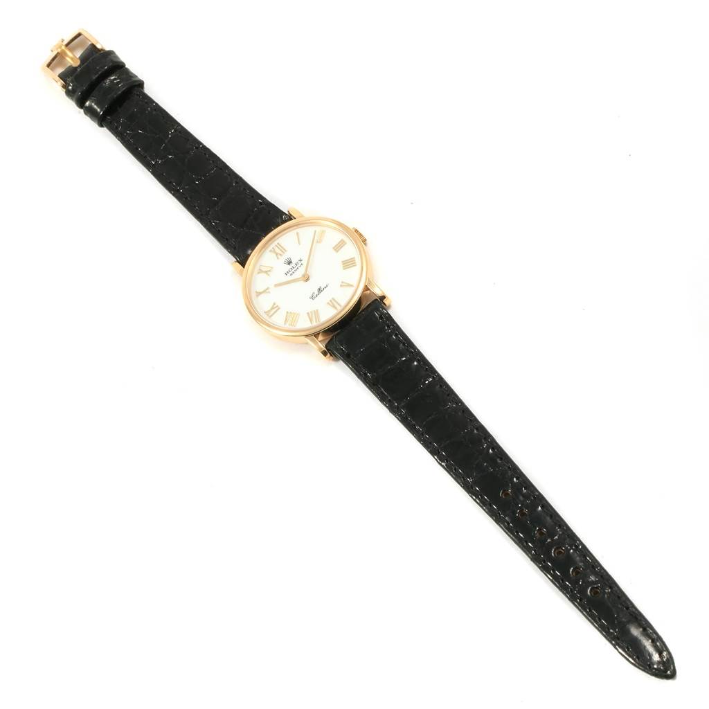 The Rolex Cellini 5109 Women's Yellow Gold White Dial 5109 Women's Yellow Gold White Dial model watch is shown from a top-down angle, displaying its face, bezel, and leather strap.