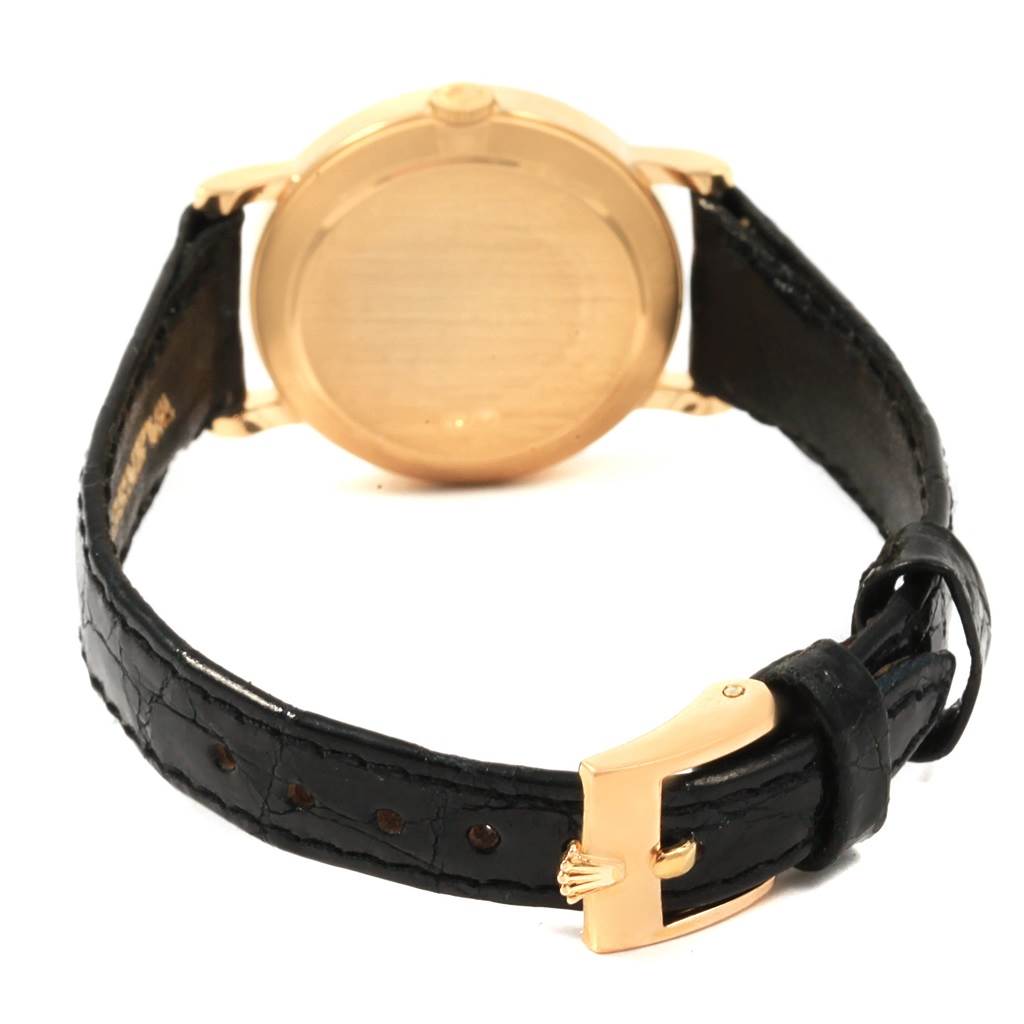 The image shows the back of a Rolex Cellini 5109 Women's Yellow Gold White Dial 5109 Women's Yellow Gold White Dial watch, including the case, crown, and black leather strap with a gold buckle.