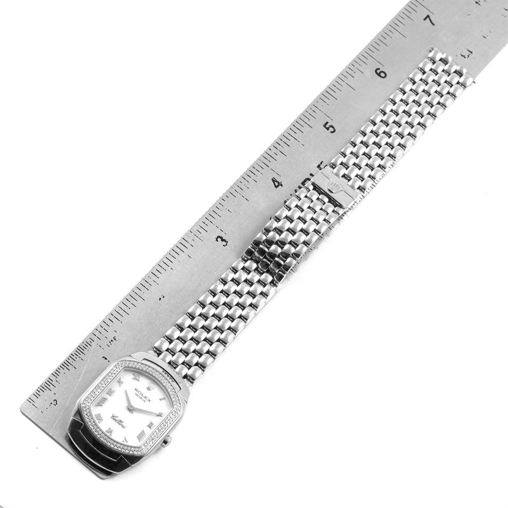The image shows a Rolex Cellini 6691 Women's White Gold White Dial 6691 Women's White Gold White Dial watch with a rectangular face and a metal bracelet, placed next to a ruler for scale.