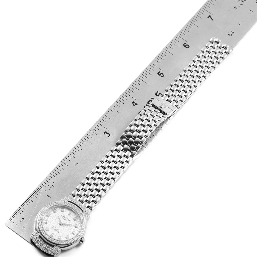 The image shows a Rolex Cellini 6673 Women's White Gold Silver Dial 6673 Women's White Gold Silver Dial watch laid flat next to a ruler, highlighting the watch face and metal bracelet.
