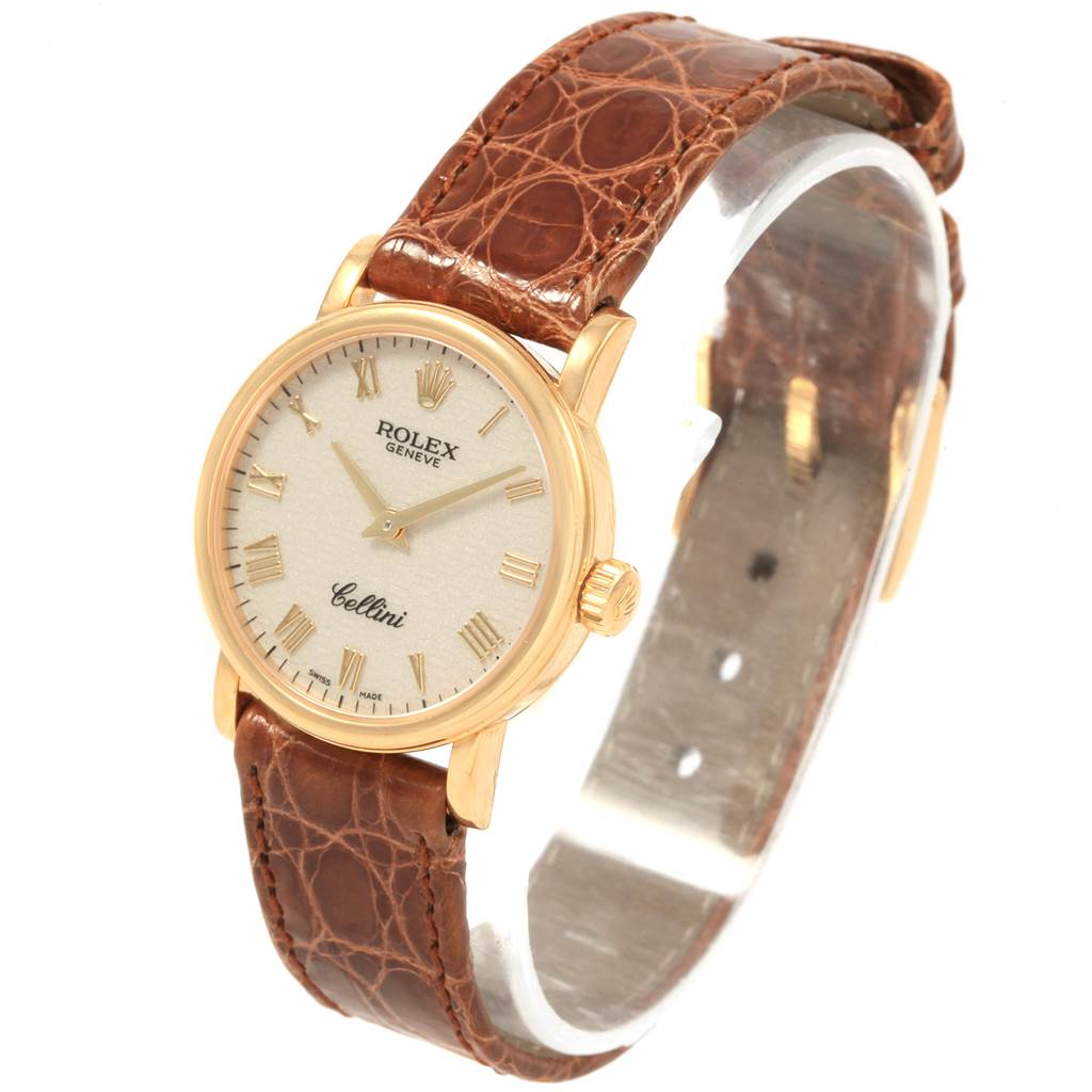 The Rolex Cellini 6110 Women's Yellow Gold Beige Dial 6110 Women's Yellow Gold Beige Dial watch is shown at a slight angle, highlighting its dial, case, crown, and brown leather strap.