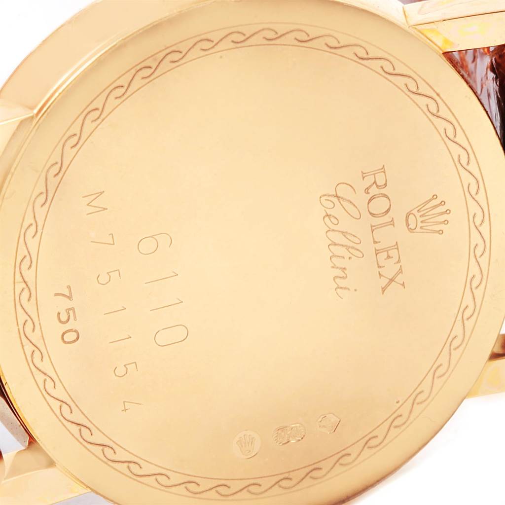 This image shows the engraved back case of a Rolex Cellini 6110 Women's Yellow Gold Beige Dial 6110 Women's Yellow Gold Beige Dial watch, including its model numbers and brand logo.