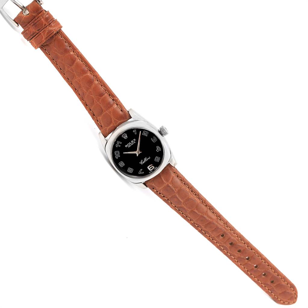 This image is a top-down view of a Rolex Cellini 6229 Women's White Gold Black Dial 6229 Women's White Gold Black Dial watch, displaying its black dial, brown leather strap, and silver case.